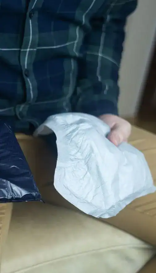 Image of man holding incontinence pads as part of overactive bladder treatment York